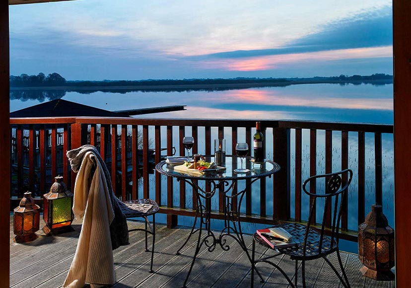 Tables and chairs on balcony overlooking the lake.